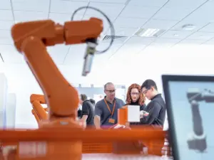 orange mechanical robot machine with computer display