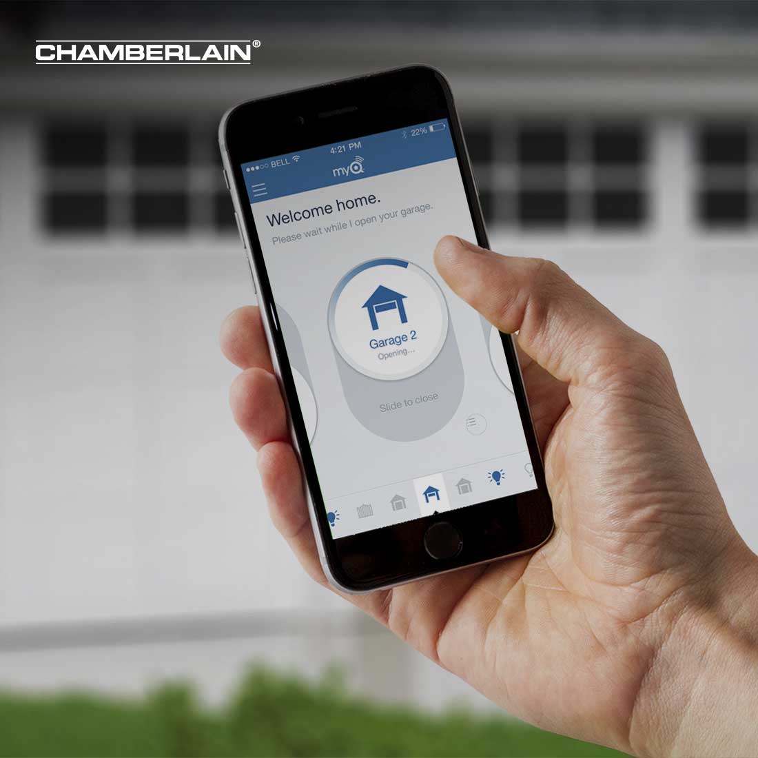Hand holding a smart home garage app with the company logo "Chamberlain" in the top left corner.