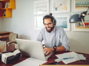 Man working from home leading a team project meeting.