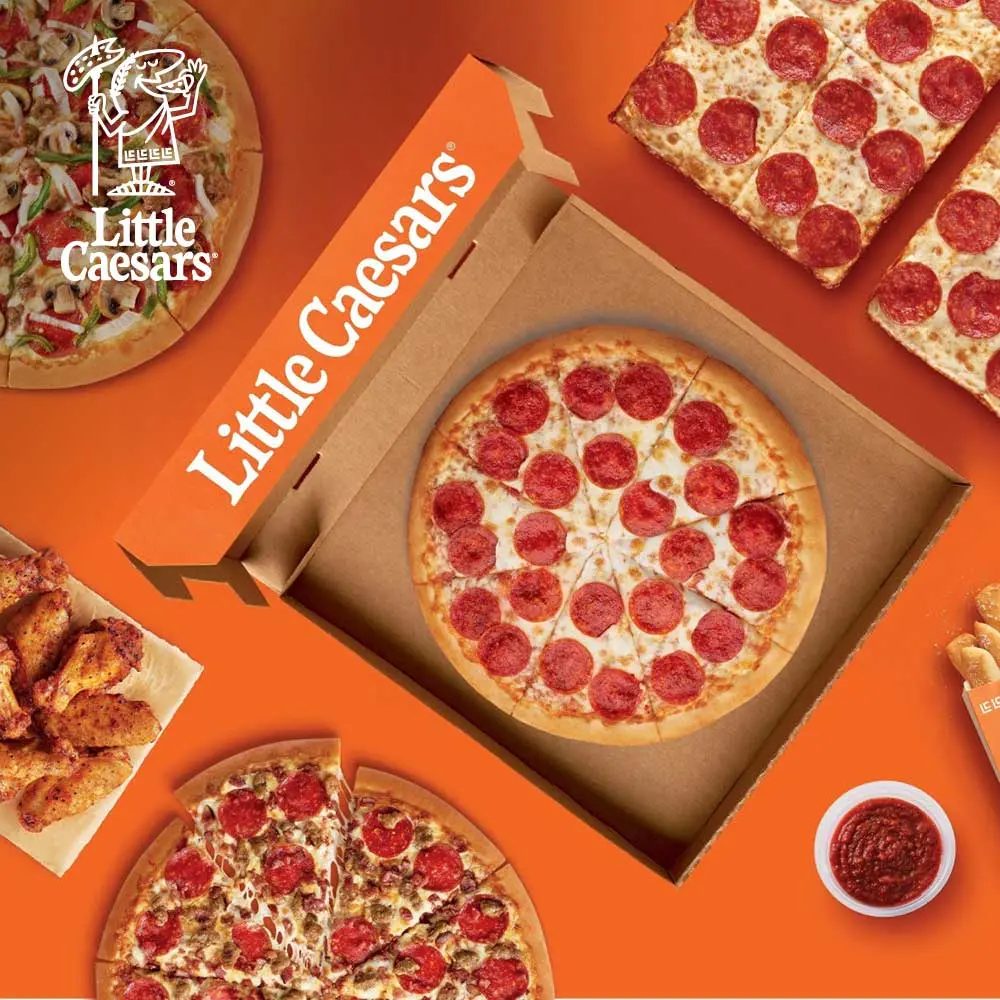 Image of a Little Caesars pizza in a pizza box. Surrounding this pizza are various other food items from Little Caesars including other pizzas, chicken wings, and bread sticks with dipping sauce. In the top left corner is the Little Caesars logo.
