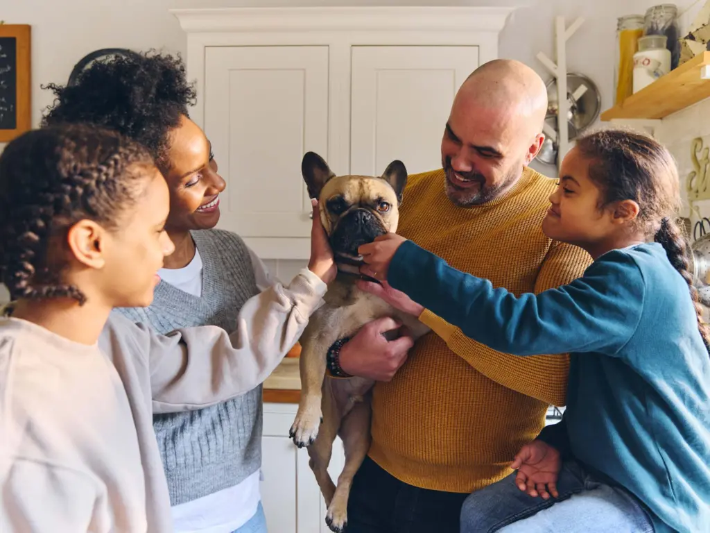 Family welcoming newly adopted dog in home