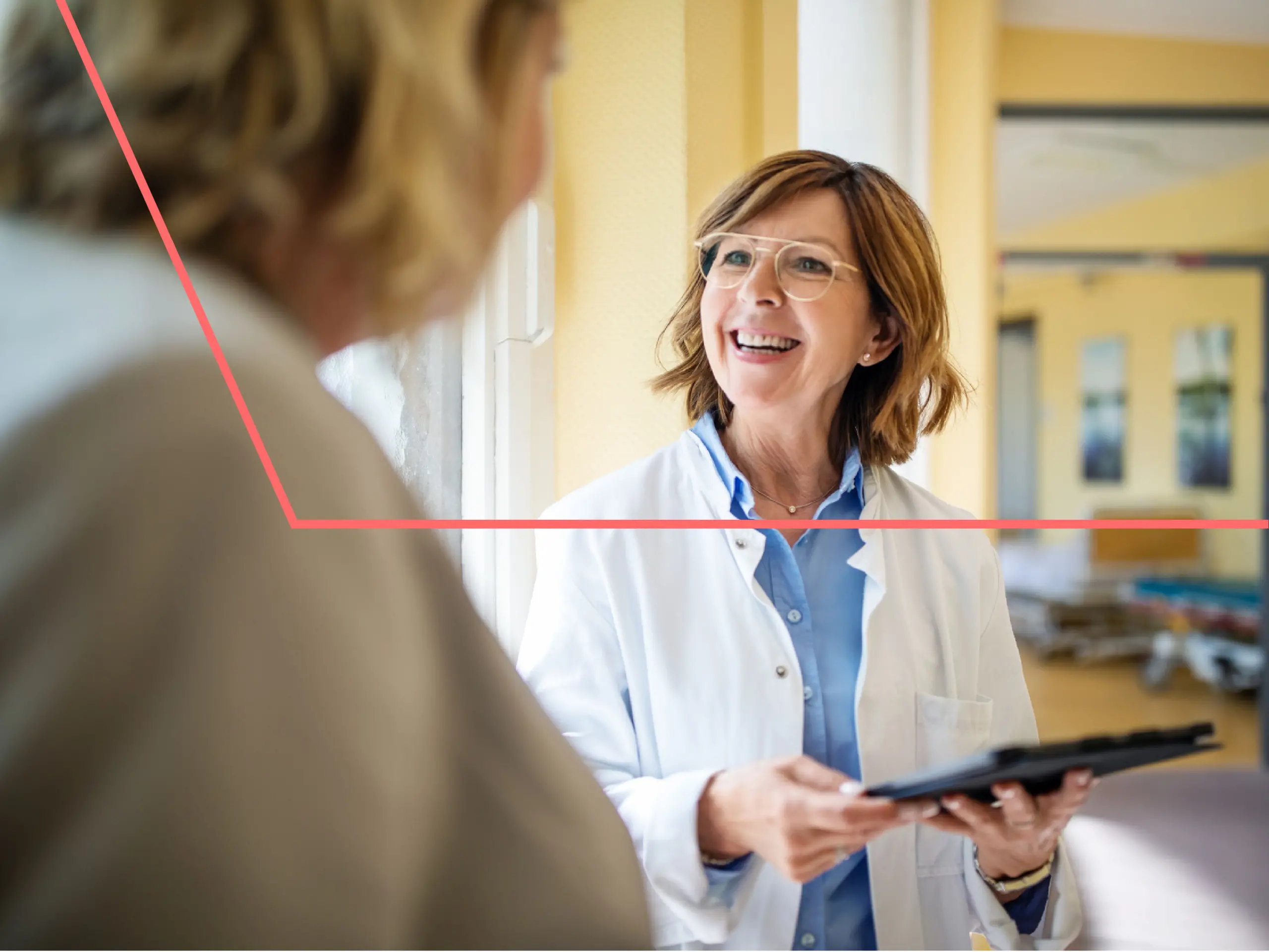 Healthcare provider smiling with patient while using a smart tablet connected to the cloud