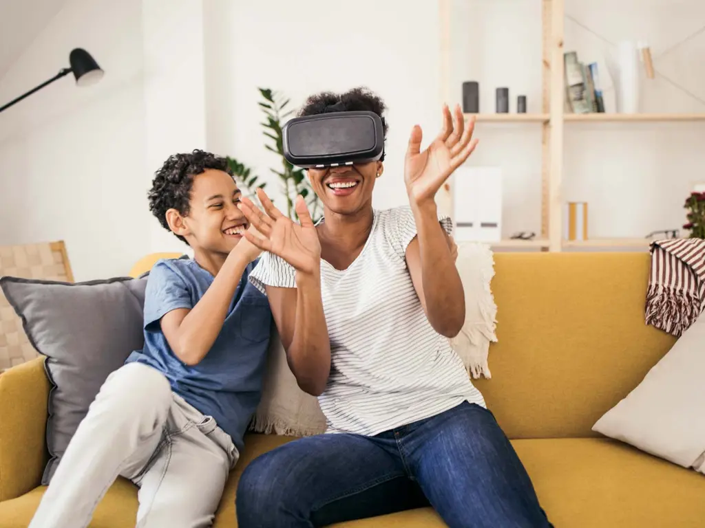 Mother and son having fun with a virtual reality headset at home.