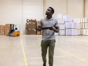 Inventory manager walking through a warehouse