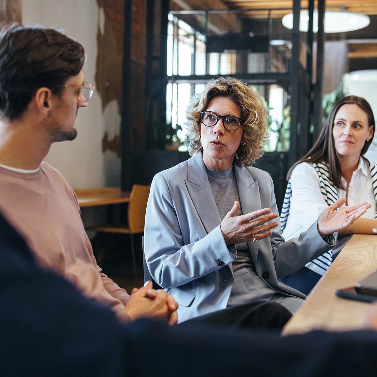 A female technology leader talking to a group of IT leaders about organizational governance