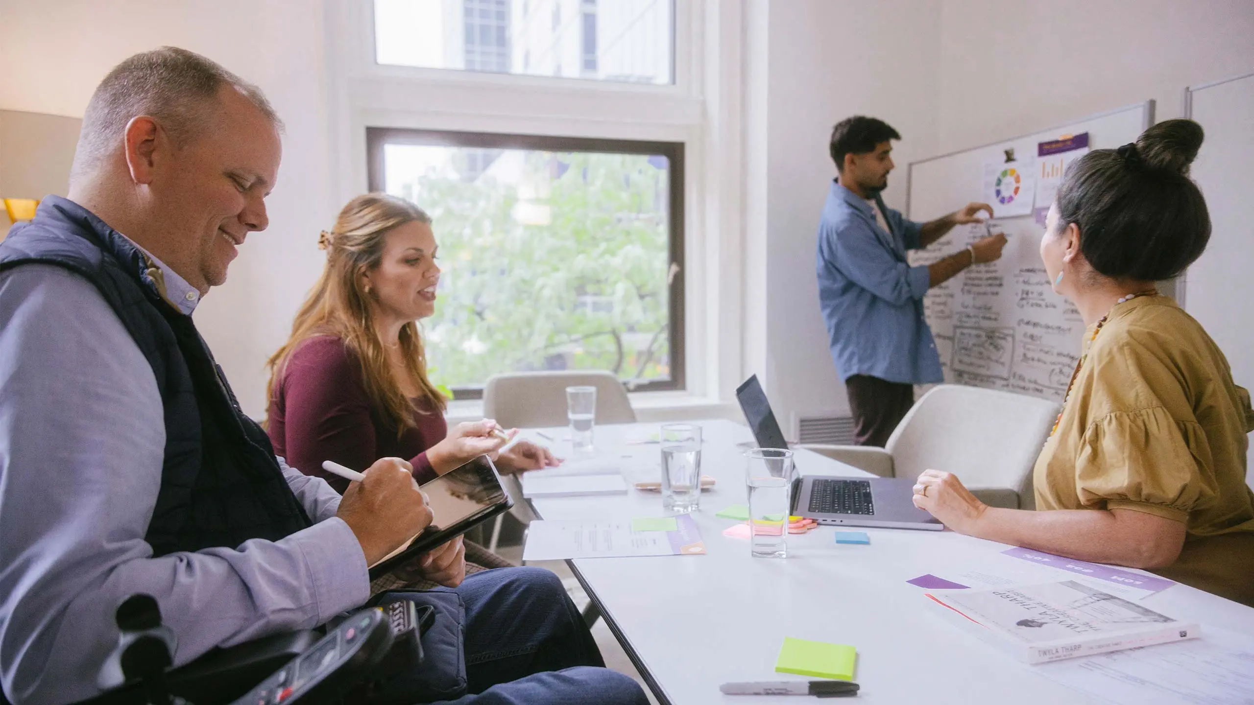 Developer presenting customer experience strategy plan on whiteboard.