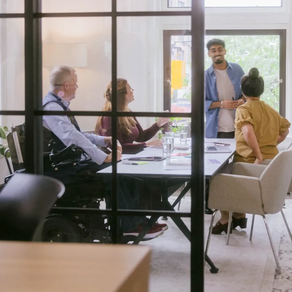 A diverse group of employees working together in a conference room