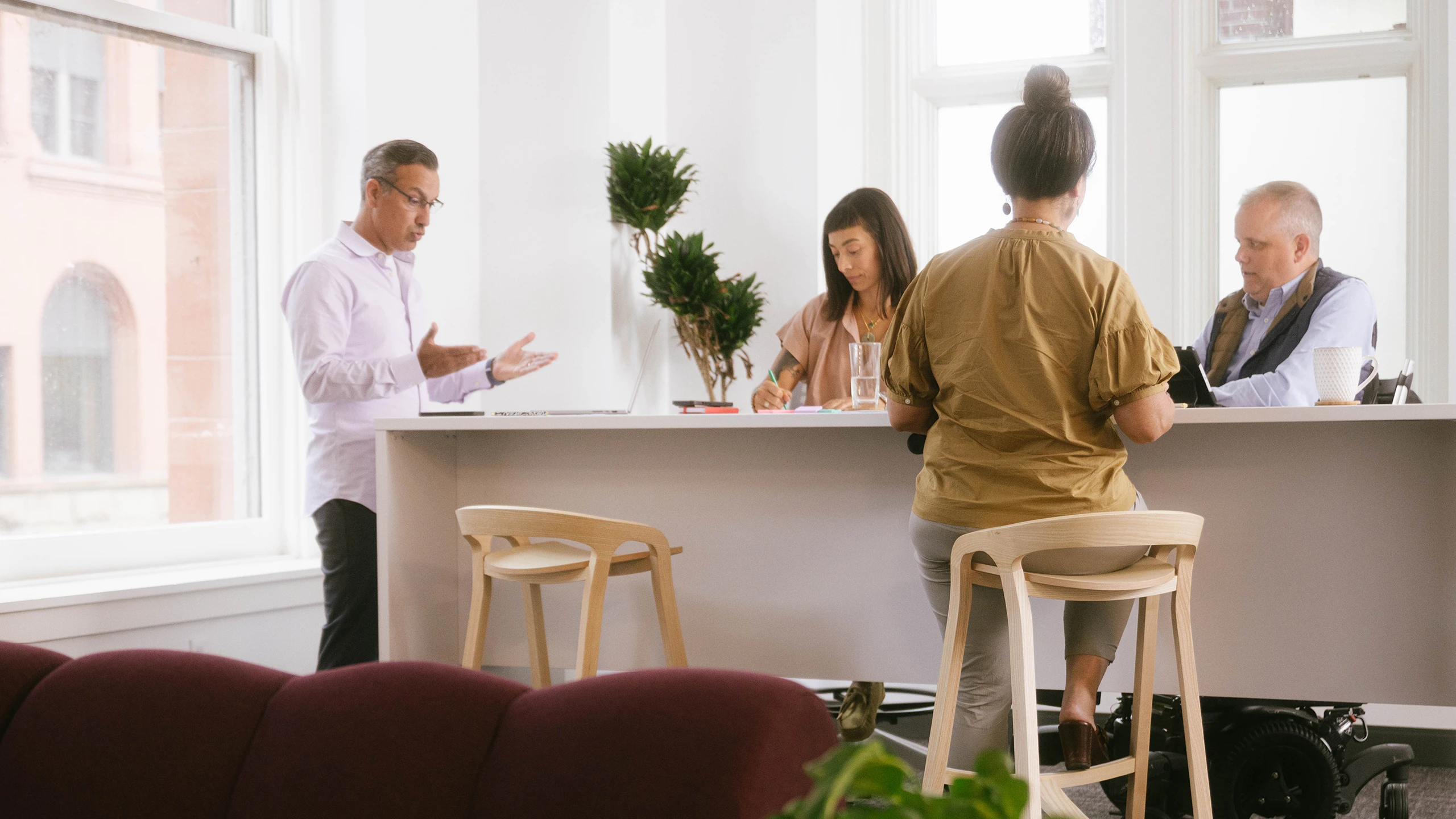 A group of IT professionals around a desk in discussions about IT Strategy and Enterprise Architecture.