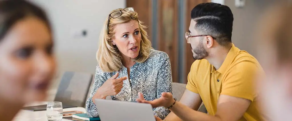 Confident woman explaining to coworker during business meeting, leadership, manager, role model