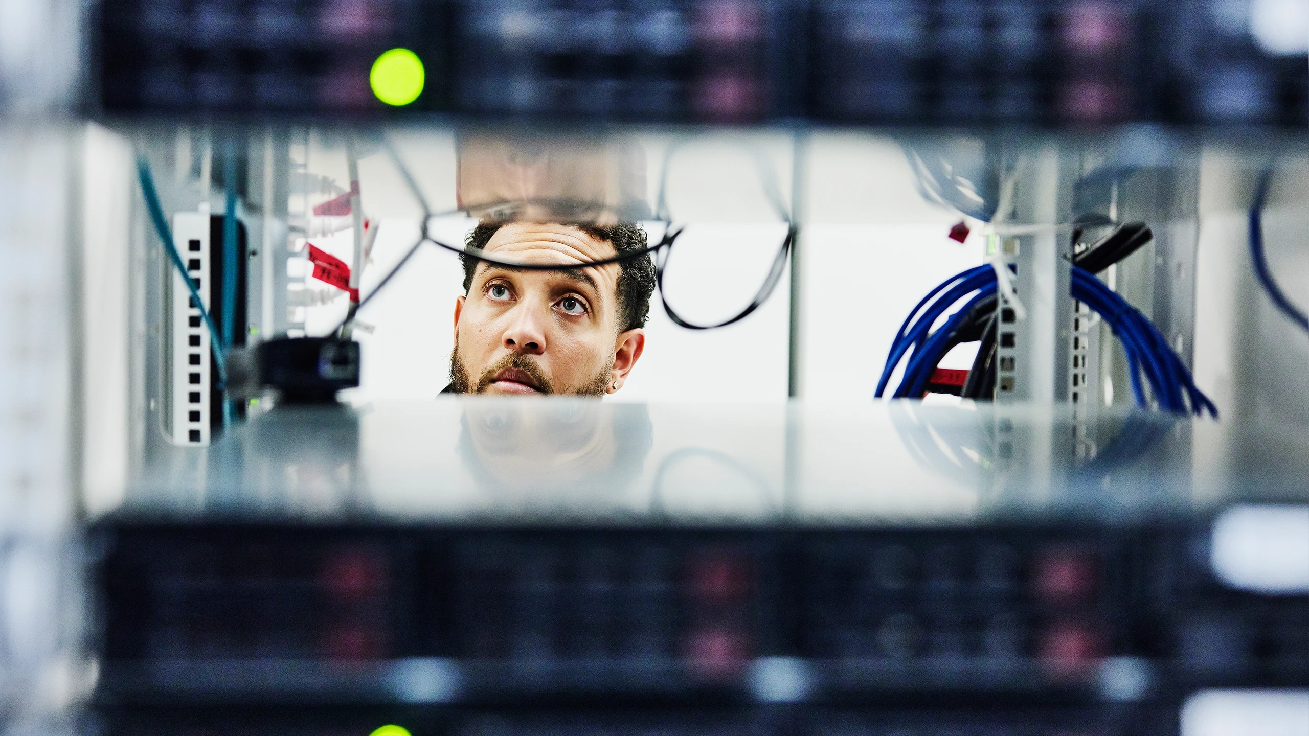 Man looking through server racks