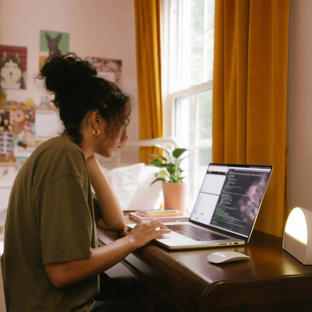 Woman working from home updating code to the cloud