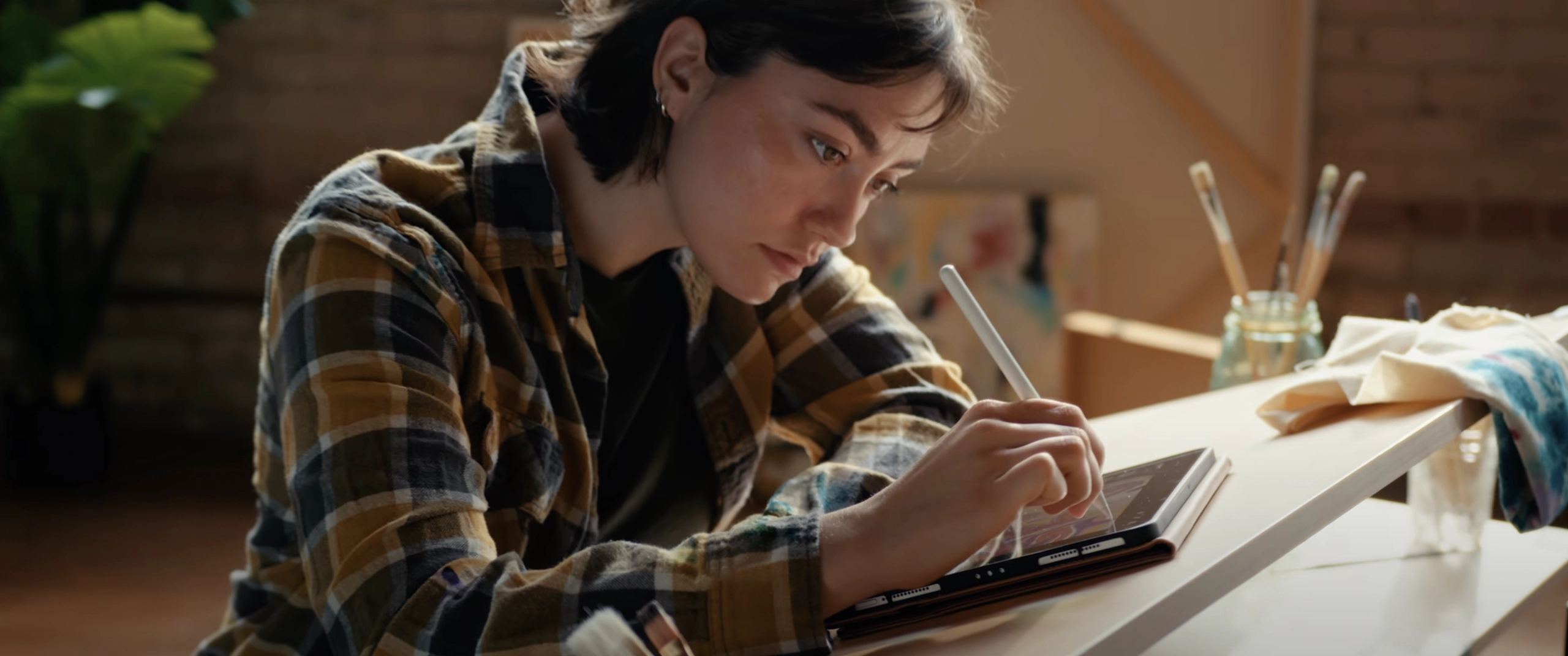 Woman designing on tablet at desk