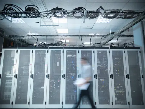 Data employee walking through server room